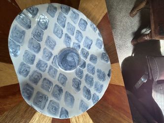 handmade ceramic decorative plate featuring a unique blue stamped square pattern and a gently wavy rim