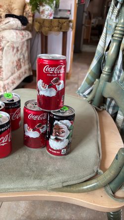 Three Santa Coca Cola cans