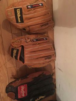 Rawlings glove and 2 Wilson gloves