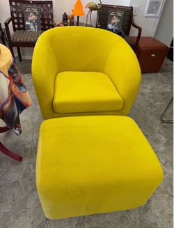 Swivel tub chair features curved arms and a matching ottoman.