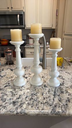 Three large candleholders candlesticks