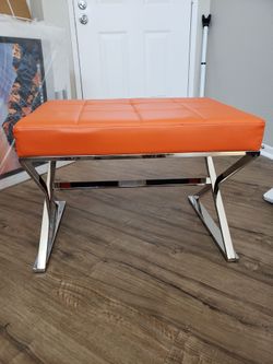 BRAND NEW. Orange Leather Tufted Ottoman with Chrome Legs