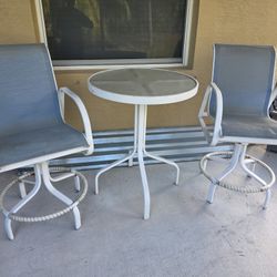 High top glass/metal table with two swivel chairs 