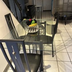 Glass table with chairs metal frame