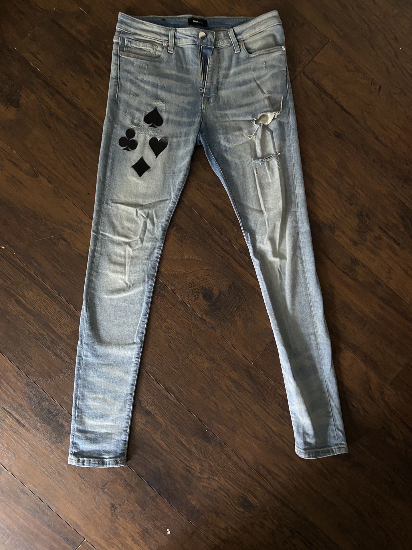 Solitaire Stacked Skinny Jeans - Medium Wash Unique distressed denim jeans with black and white playing card patches