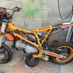 Orange venom  bike. Has a visible engine and orange frame. Needs some work or good for parts