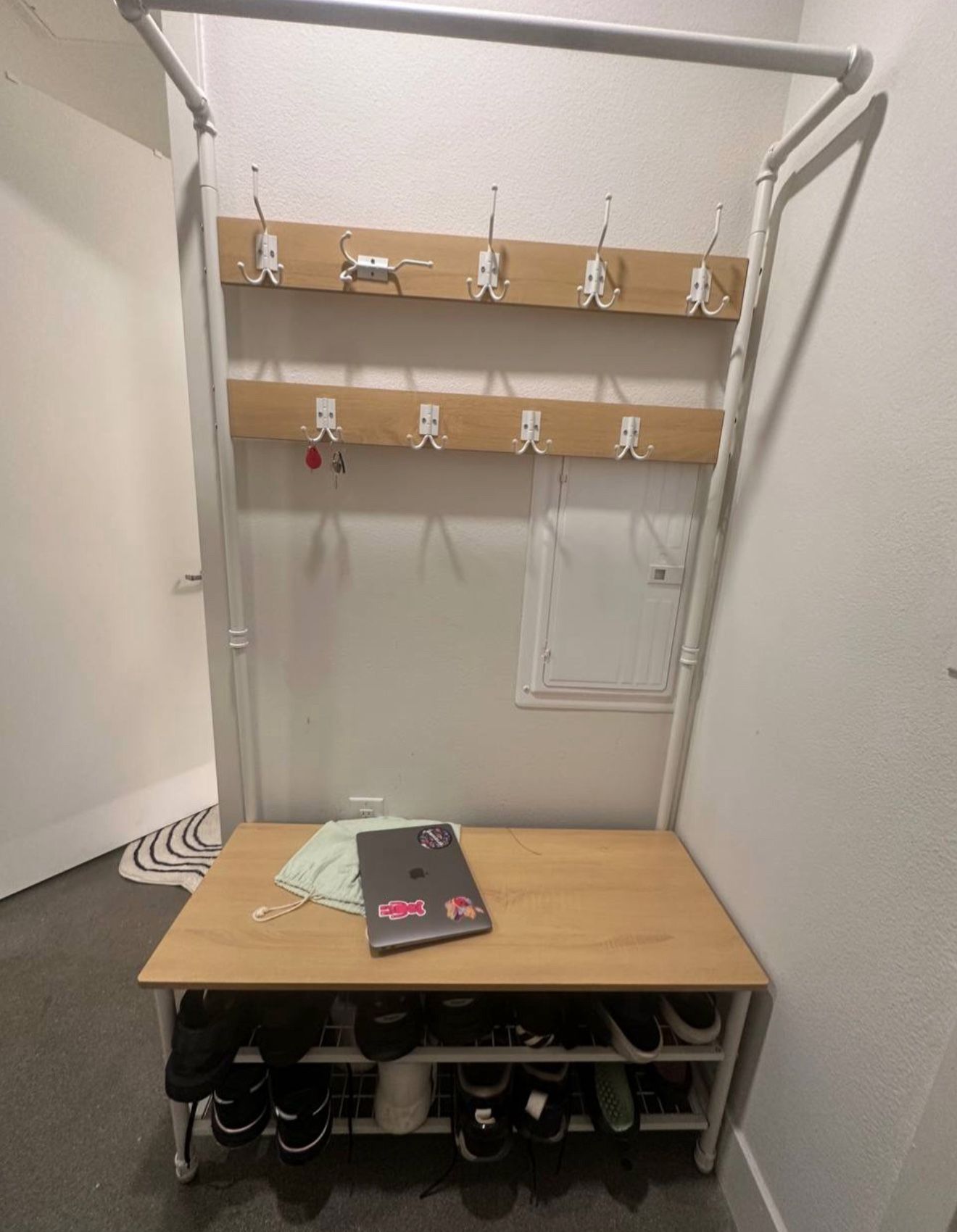 Entryway coat rack with bench and shoe storage