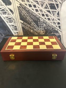 portable wooden chess set with gold and chrome finished metal pieces.
