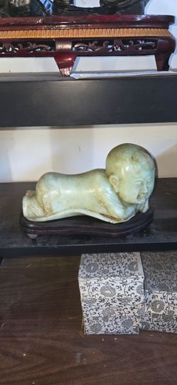 Beautiful hand carved Jade baby on a pillow