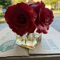 Beautiful large red roses in a glass base
