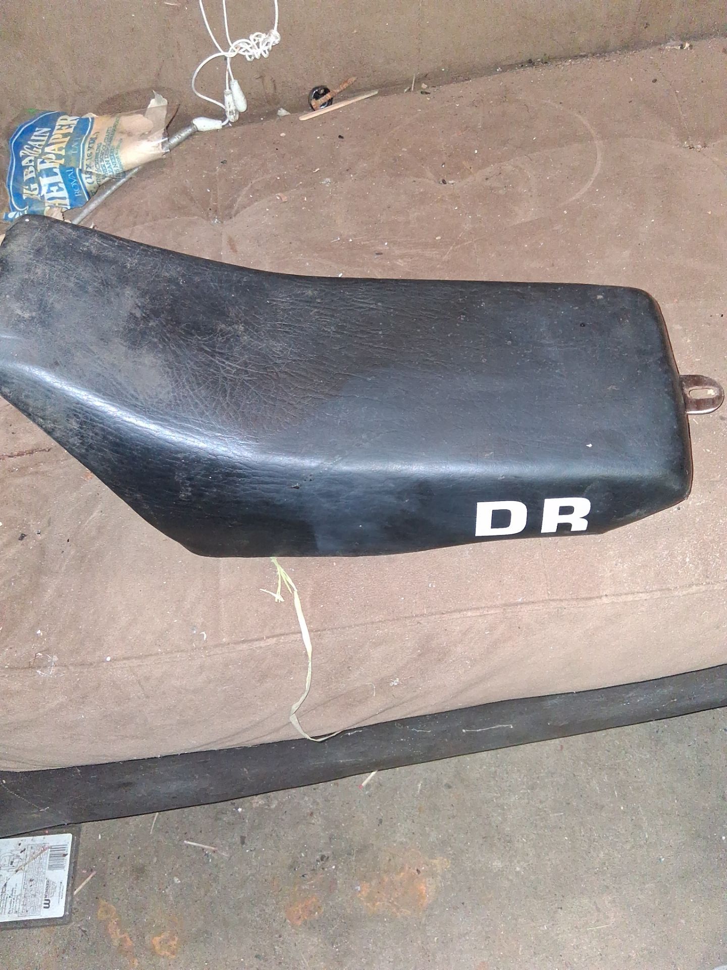 This is a black Suzuki DR 125 motorcycle seat.This seat is designed for older Suzuki DR series dirt bikes.