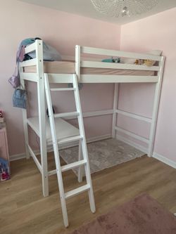 White twin bunk bed with desk