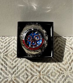 Invicta Akula Quartz Chronograph 44296 with a 55mm case featuring red, blue, and silver-tone accents.