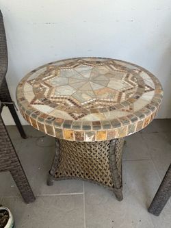 Outdoor stone mosaic and rattan table