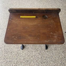 This is an antique school desk manufactured by "Peabody-Stigglemann Co