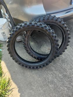 Two dirt break tires, one hundred by ninety by nineteen fifty seven M. Dunlop