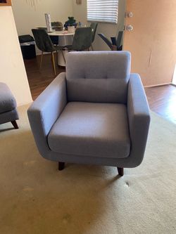 Grey chair with foot rest
