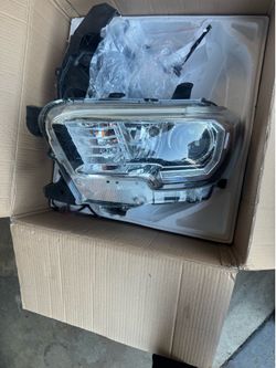 Brand new Toyota Tacoma driver-side LED headlight still in the original box.