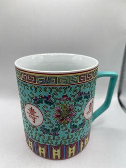 a traditional Chinese Jingdezhen turquoise porcelain mug featuring the Wan Shou Wu Jiang (ä¸‡å¯¿æ— ç–†) longevity pattern.