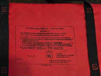 red Type IV PFD (Personal Flotation Device) throwable flotation cushion with black grab straps