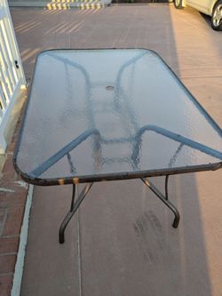 GLASS PATIO TABLE 38.5" wide x 54.75" long x 28" high