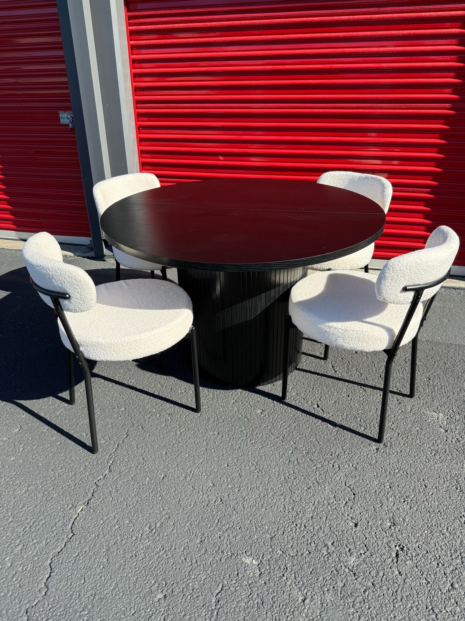 Black Barrel Dining Table And Boucle Chairs 