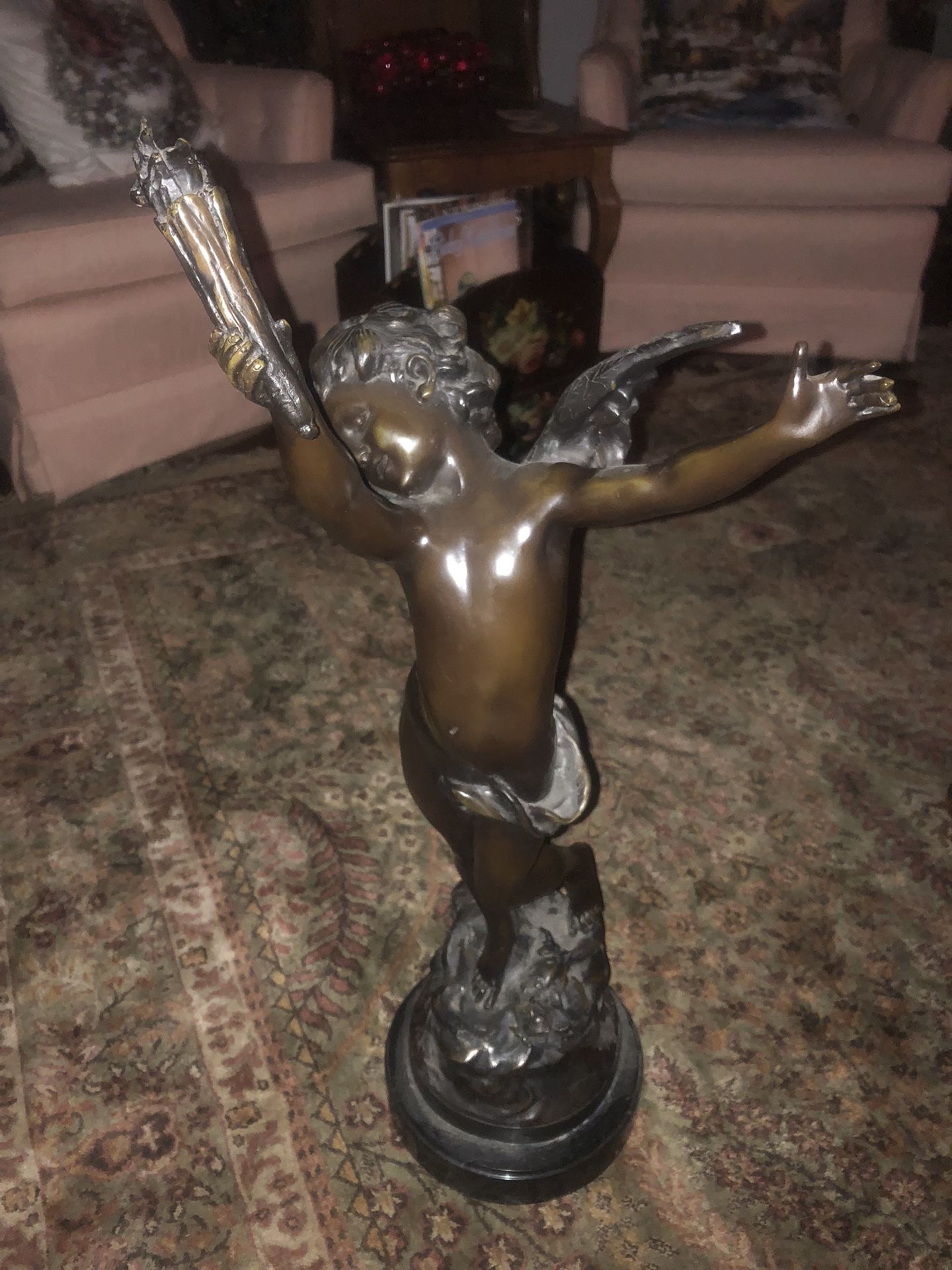 The Bronze Sculpture Depiction Of Cupid