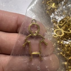 gold-colored child-shaped necklace pendant