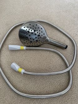 handheld shower head with a flexible stainless steel hose attached, finished in brushed nickel.