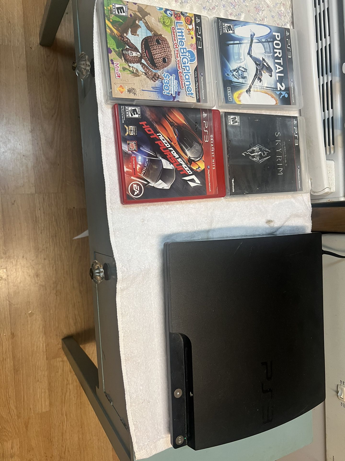 PlayStation 3 with games and one controller