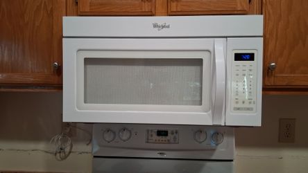 Microwave Whirlpool white over stove with light and exhaust. Works great