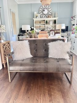 Brown faux leather loveseat with gold frame, easily wipeable and to clean. like new