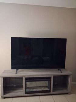 65in  with a fire place tv stand