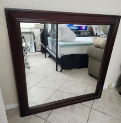 48 in by 48-in hanging wall mirror with a 4-in wood trim