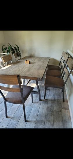 Dinning furniture set combines a modern industrial design with warm rustic farmhouse elements.