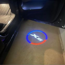 2 BMW X5 car door projector lights.  X3 X4 X5 X6 X7, Performance M available, Rim center caps, seat belt pads, Emblems Sold Separate Available.  SHIPS