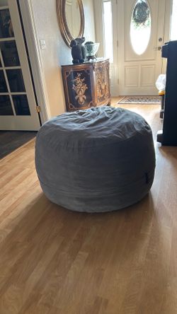 Large bean bag like chair filled with pieces of foam.  It has been used twice.  The foam inside smashes down when used over time.  It has no tears or 