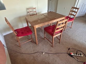 Wooden dining table with four chairs