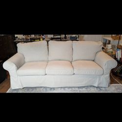 Beige three-seat sofa