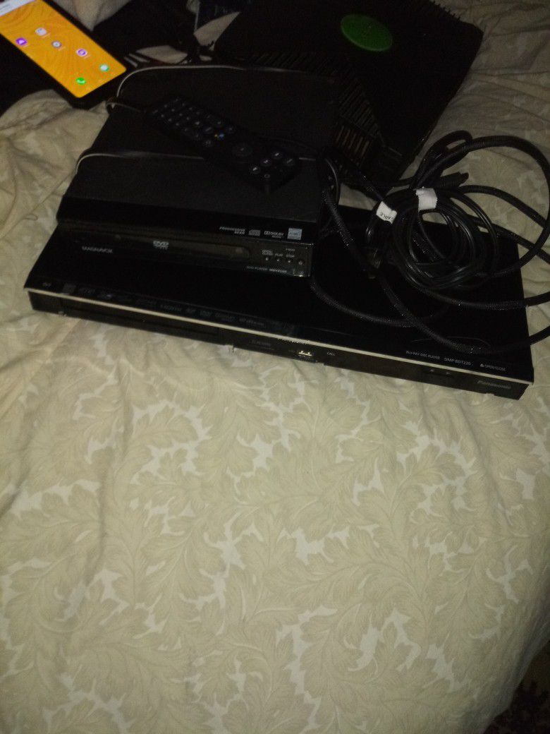 2 Dvd Players One Panosonic Blu Ray W Remote And HDMI Cable One Reg Magnavoc Dvd W Cords