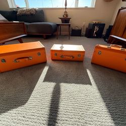 3 Orange faux leather cases that fit into each other