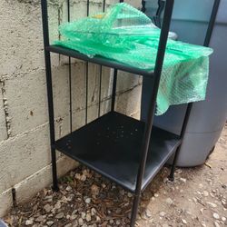 Tall black shelf with glass