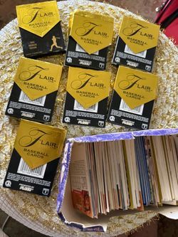 Lot of 7 Flair Ltd. baseball card packs by Fleer, including one 1993 Premiere Edition pack. Also includes a box of loose baseball cards.