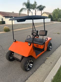 Ezgo Golf Cart 1987 Harley orange with charger- runs good.