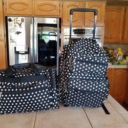 Polka dotted luggage with multiple pockets and compartments