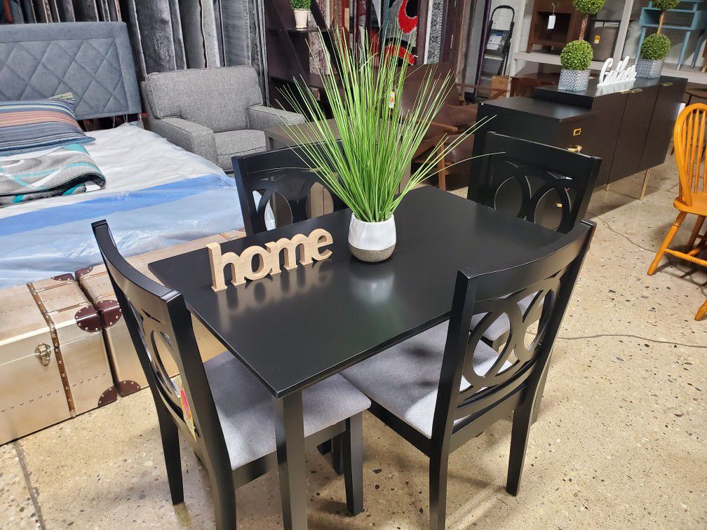 small black 5 pc dining set with gray  fabric seats 
