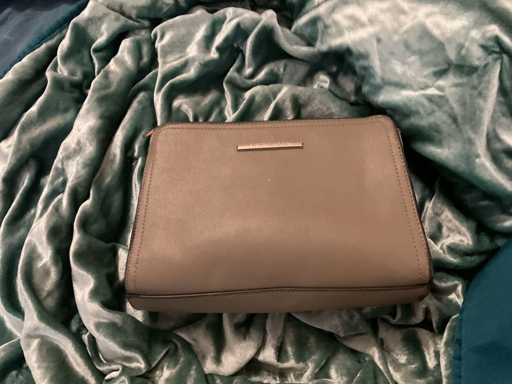 Has A Lot Of Pockets, A Little Pouch In The Back And A Straap