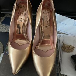 These are a pair of Ted Baker London heels in a beautiful gold color! They are a size 8. Perfect for a night out or a special occasion