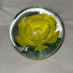 Vintage Art Glass Paperweight with aYellow Flower and Green Stems. Bubbles Throughout the Glass.
