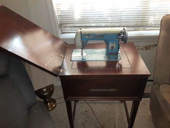 Vintage Montgomery Ward Signature sewing machine in cabinet